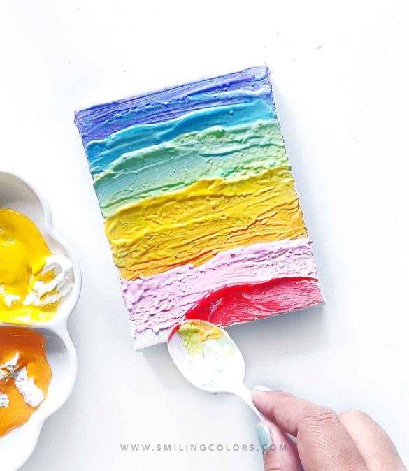 Painting with a spoon: Create an easy rainbow canvas with no paintbrush!